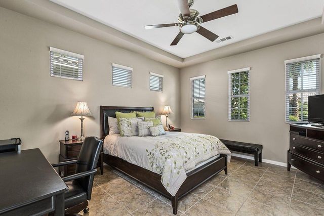 a bedroom with a bed and a lamp on table