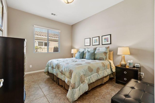 a spacious bedroom with a bed and window