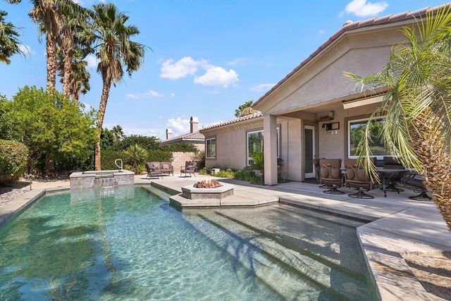 a view of a house with backyard porch and sitting area