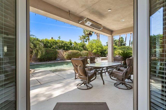 a view of balcony with furniture and garden
