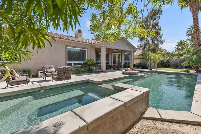 a view of a house with a yard patio and swimming pool
