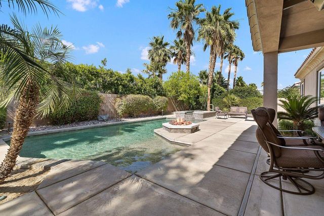 a view of a backyard with plants and a patio