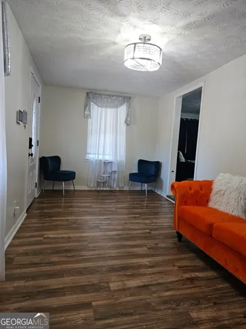 a room with furniture wooden floor and a window