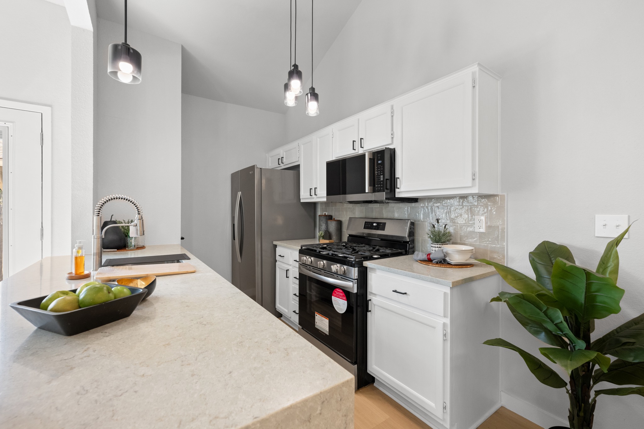 6501 Brush Country Road, Unit 120 Austin, TX 78749 - Photo 7 of 26 Kitchen featuring white cabinetry with matte black hardware and brand new stainless steel appliances
