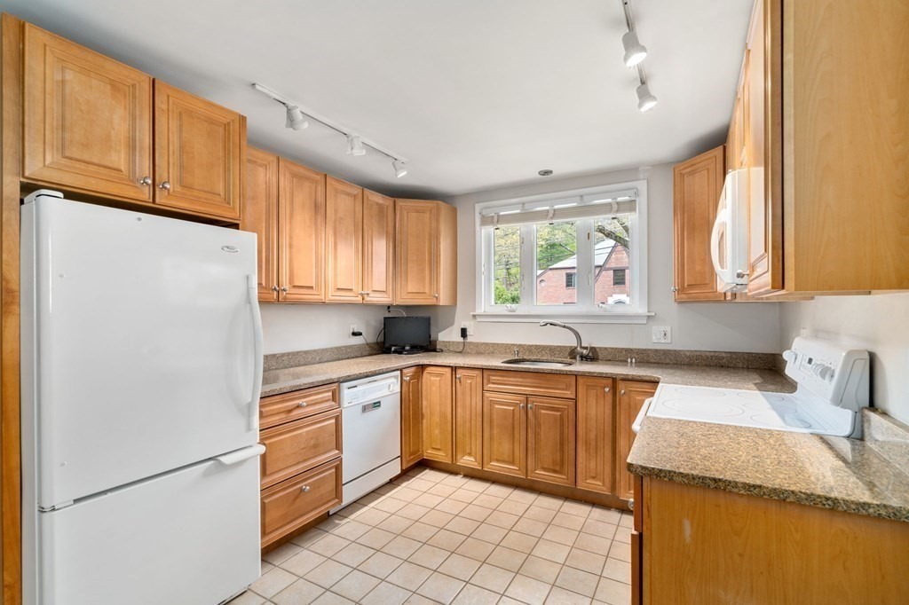 73 Beverly Road Chestnut Hill, MA 02467 - Photo 6 of 21 a kitchen with granite countertop cabinets stainless steel appliances a sink and a window