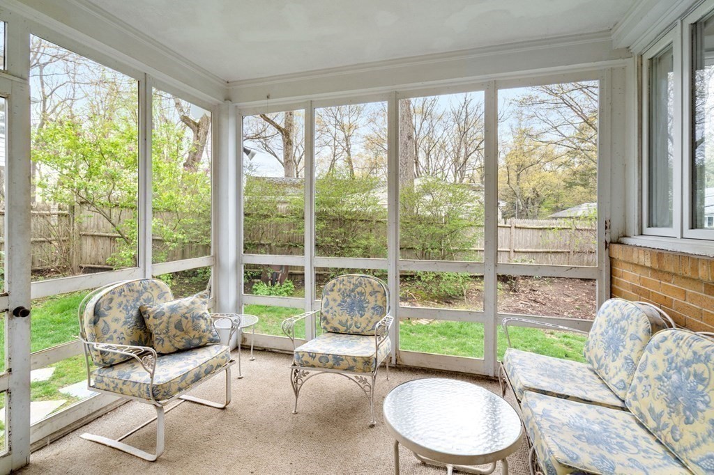 73 Beverly Road Chestnut Hill, MA 02467 - Photo 9 of 21 a living room with furniture and a large window with garden view
