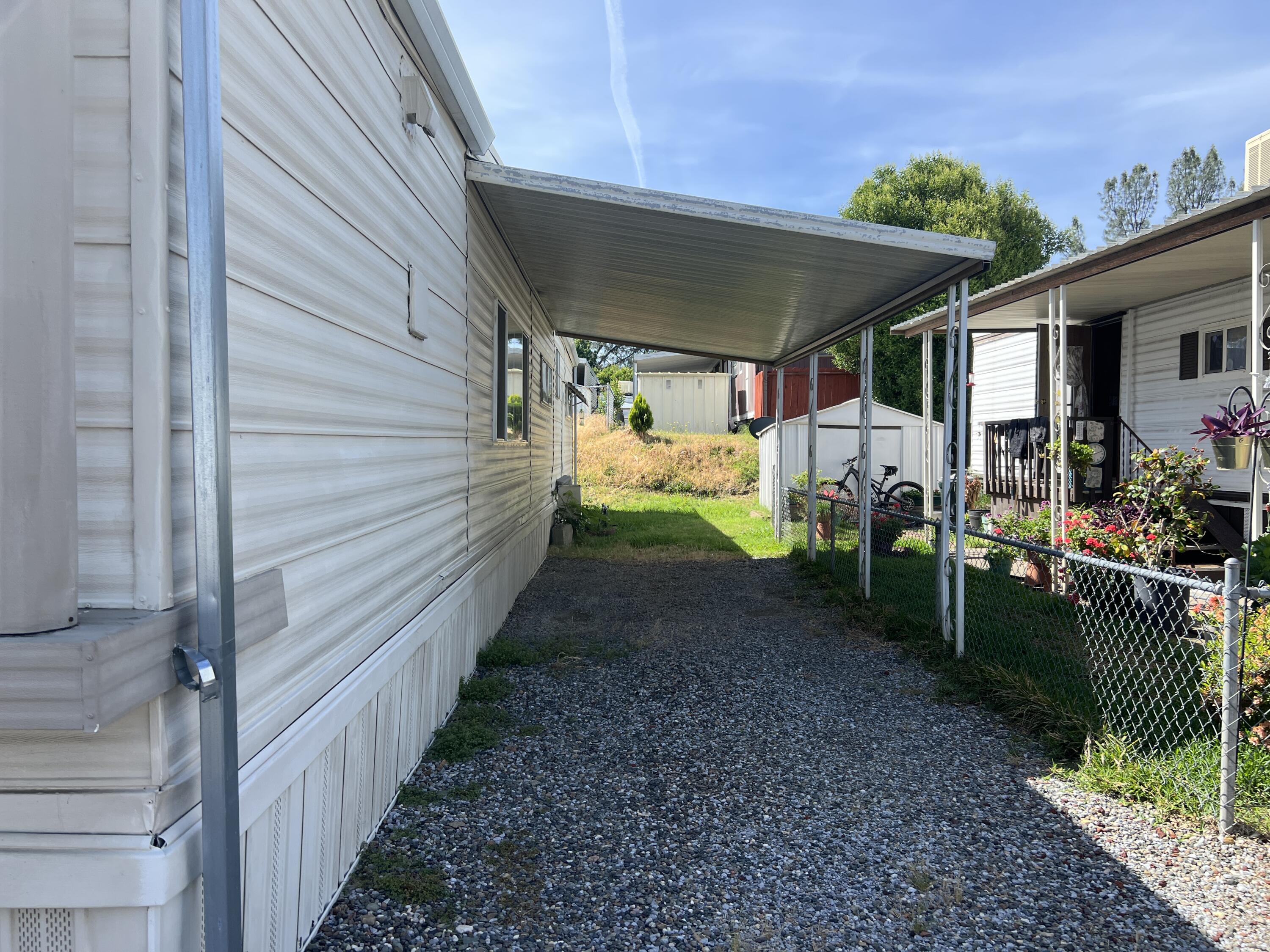 481 Twin View Boulevard, Unit 35 Redding, CA 96003 - Photo 14 of 17 a view of a patio with table and chairs under an umbrella