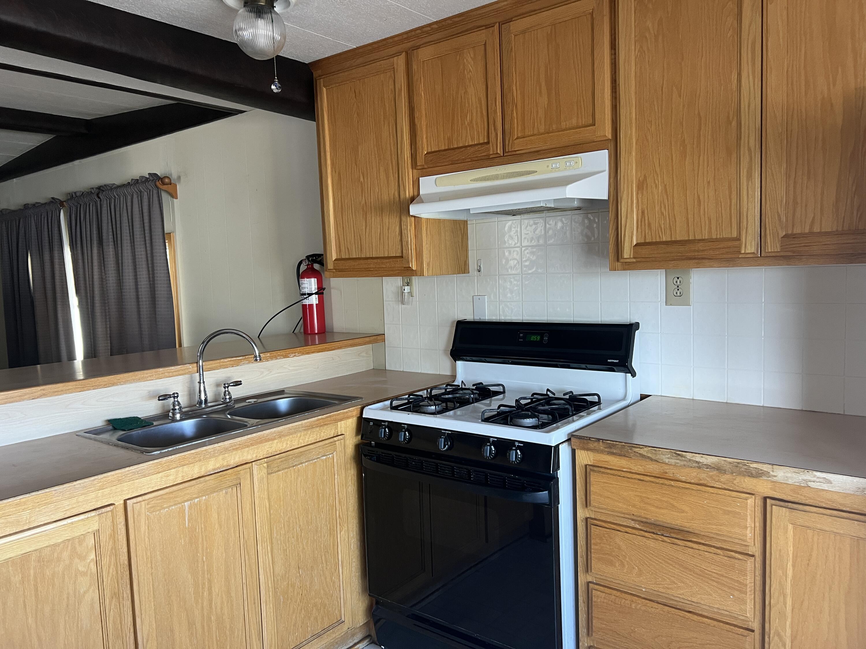 481 Twin View Boulevard, Unit 35 Redding, CA 96003 - Photo 3 of 17 a kitchen with stainless steel appliances granite countertop a sink stove and cabinets