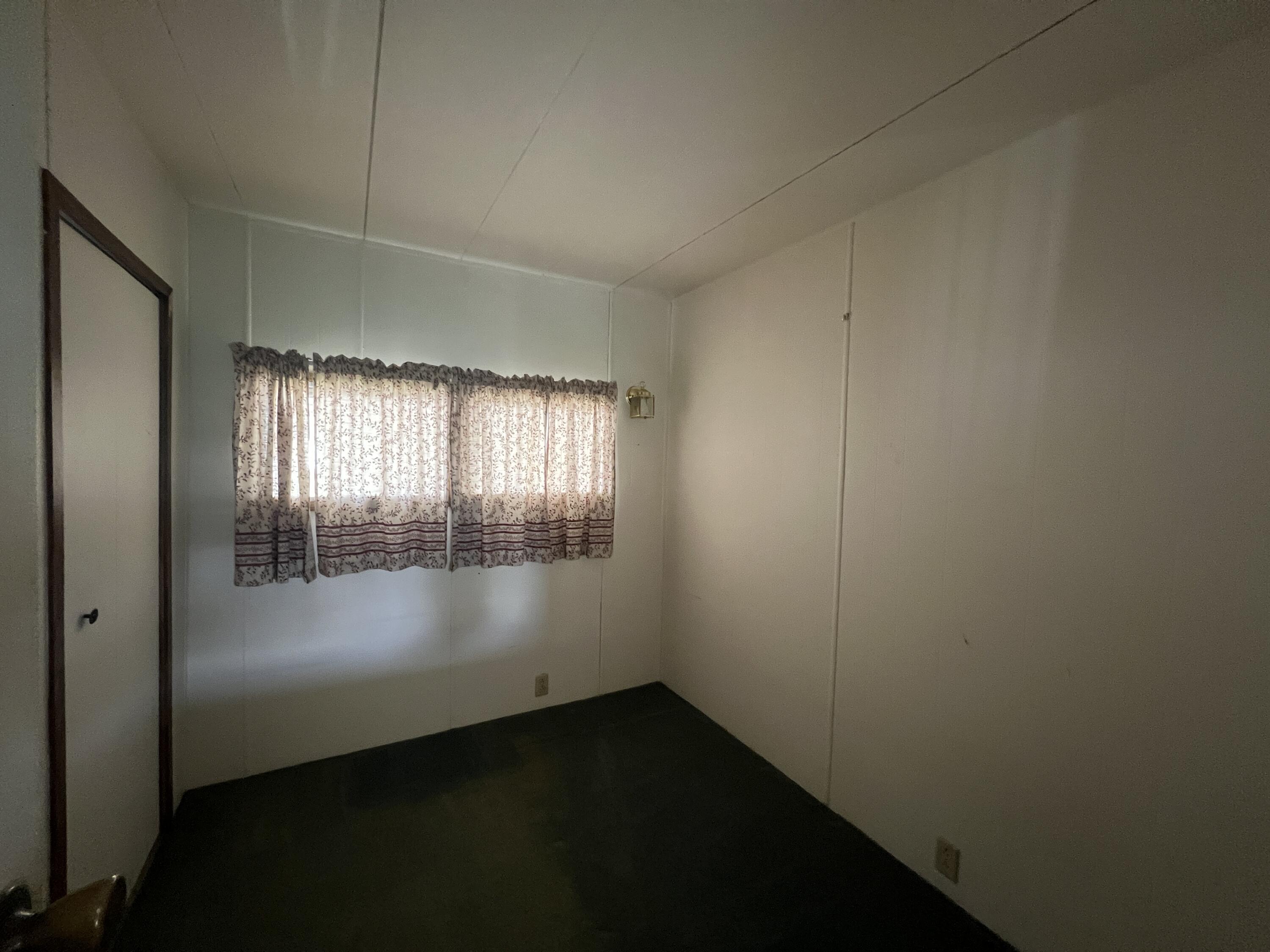 481 Twin View Boulevard, Unit 35 Redding, CA 96003 - Photo 5 of 17 an empty room with wooden floor and windows