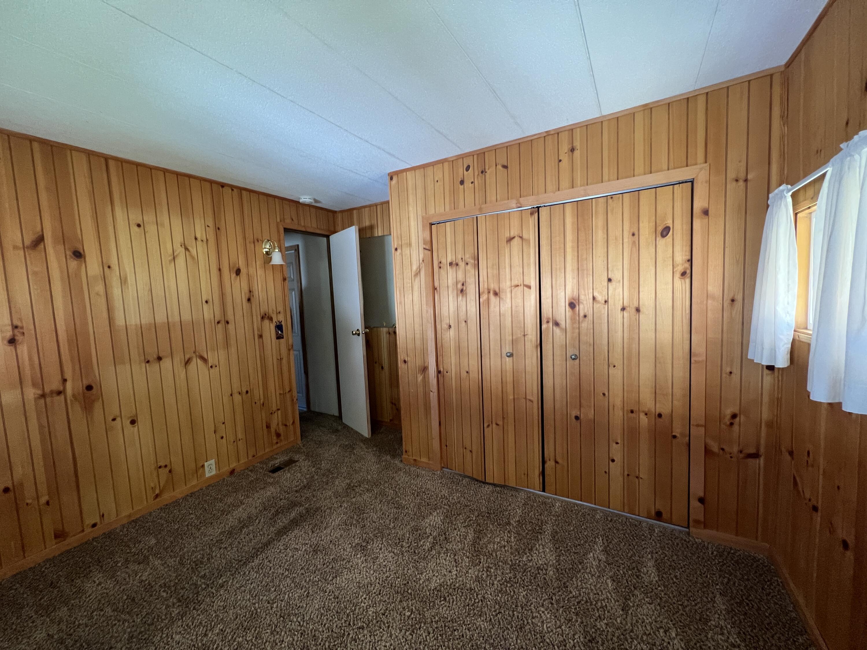 481 Twin View Boulevard, Unit 35 Redding, CA 96003 - Photo 8 of 17 a view of an empty room with wooden walls