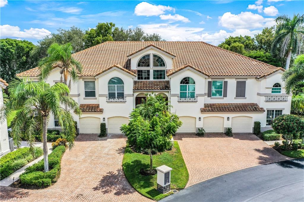 217 Colonade Circle Naples, FL 34103 - Photo 16 of 40 a front view of a house with a yard