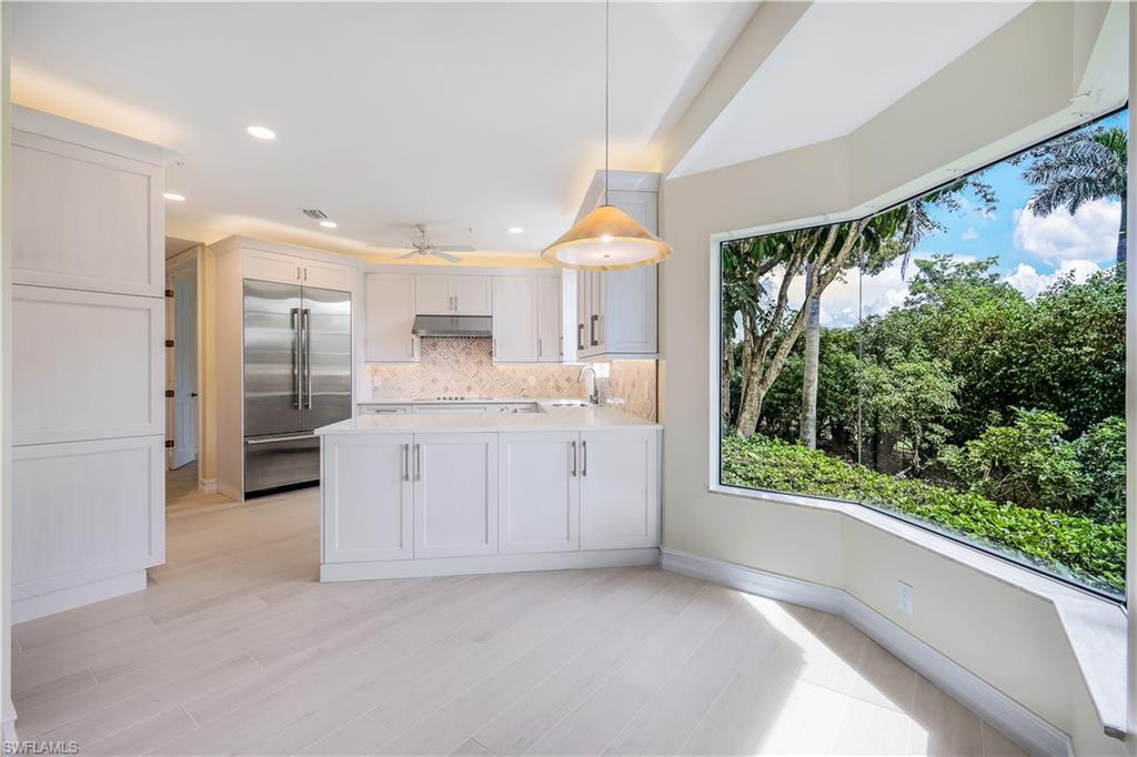 217 Colonade Circle Naples, FL 34103 - Photo 19 of 40 a large white kitchen with a large window