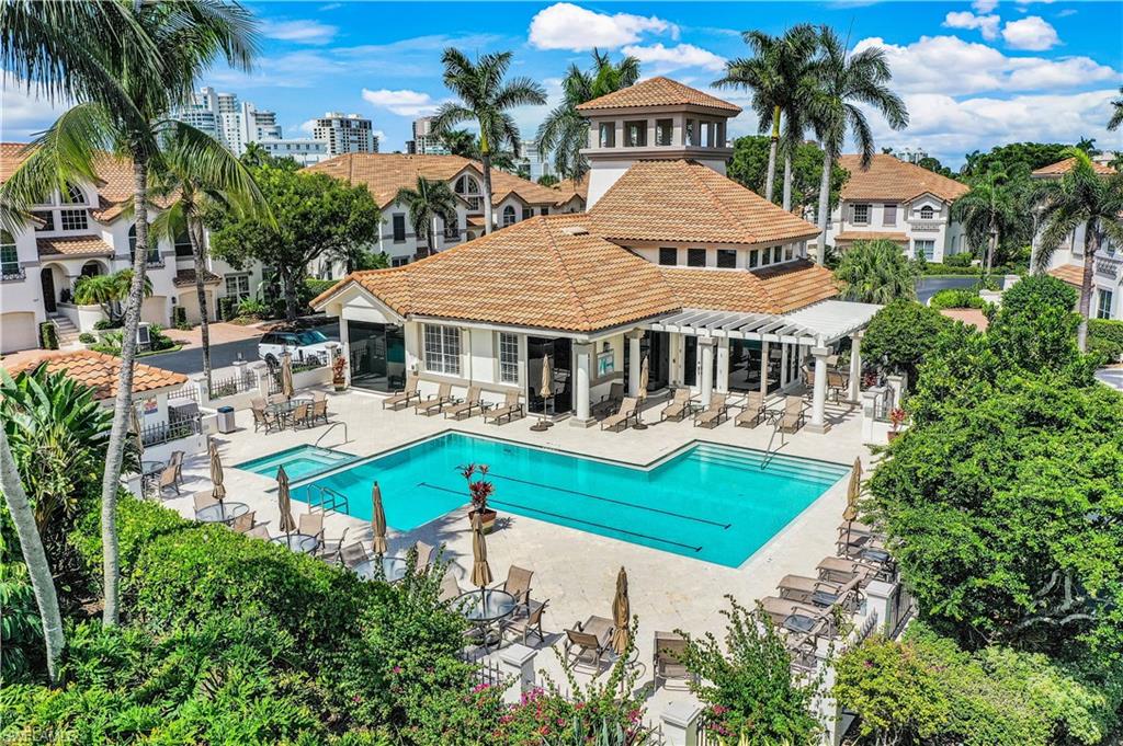 217 Colonade Circle Naples, FL 34103 - Photo 2 of 40 a aerial view of a house with swimming pool and lounge chairs