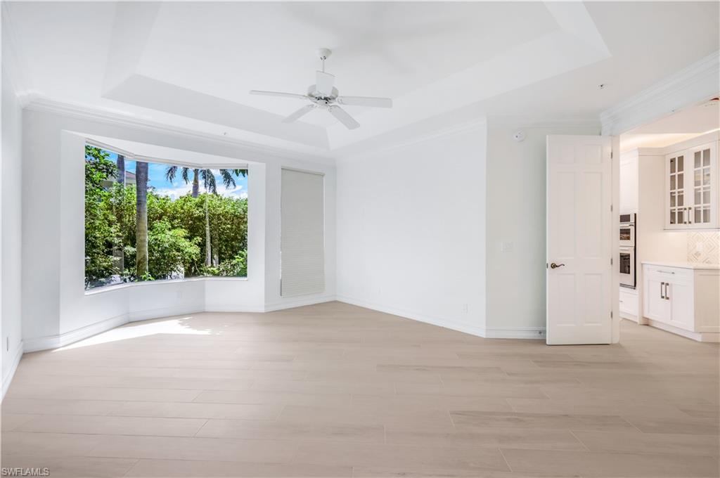 217 Colonade Circle Naples, FL 34103 - Photo 22 of 40 a view of a livingroom with a ceiling fan and window
