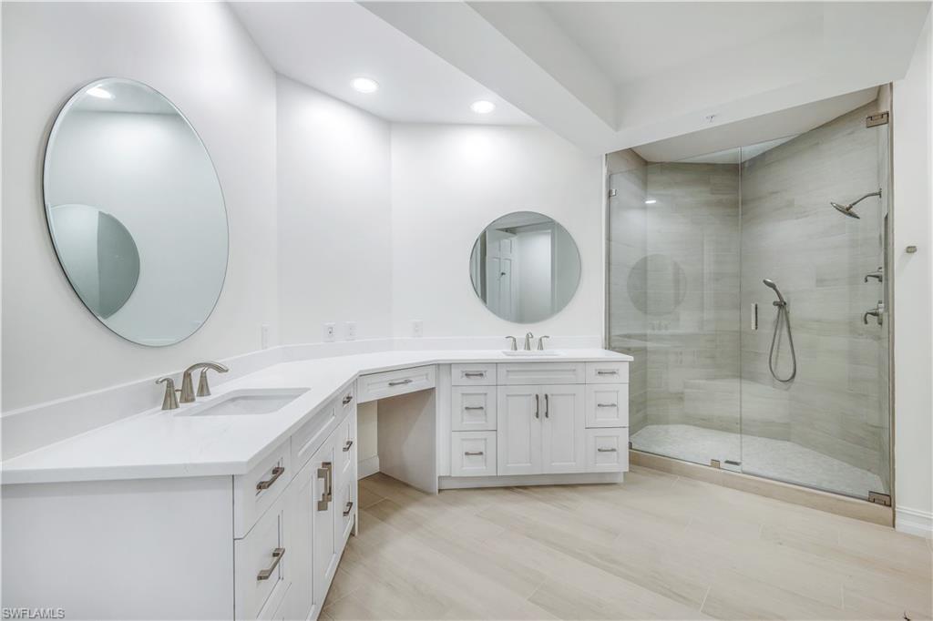 217 Colonade Circle Naples, FL 34103 - Photo 25 of 40 a spacious bathroom with a double vanity sink mirror and bathtub