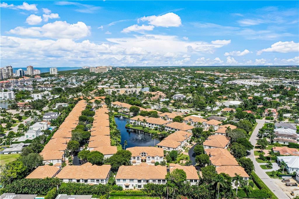 217 Colonade Circle Naples, FL 34103 - Photo 3 of 40 an aerial view of residential building and lake