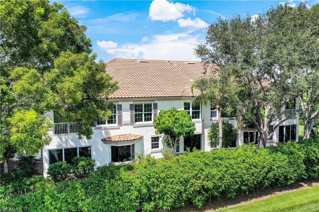 217 Colonade Circle Naples, FL 34103 - Photo 33 of 40 front view of a house with a yard