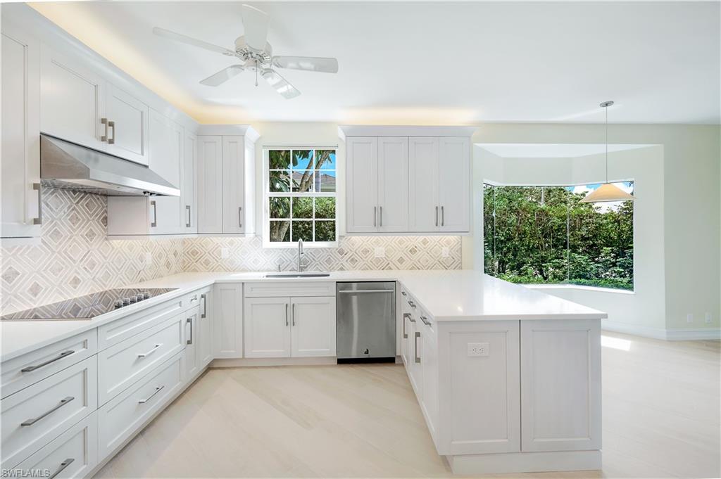 217 Colonade Circle Naples, FL 34103 - Photo 6 of 40 a kitchen with sink cabinets and window