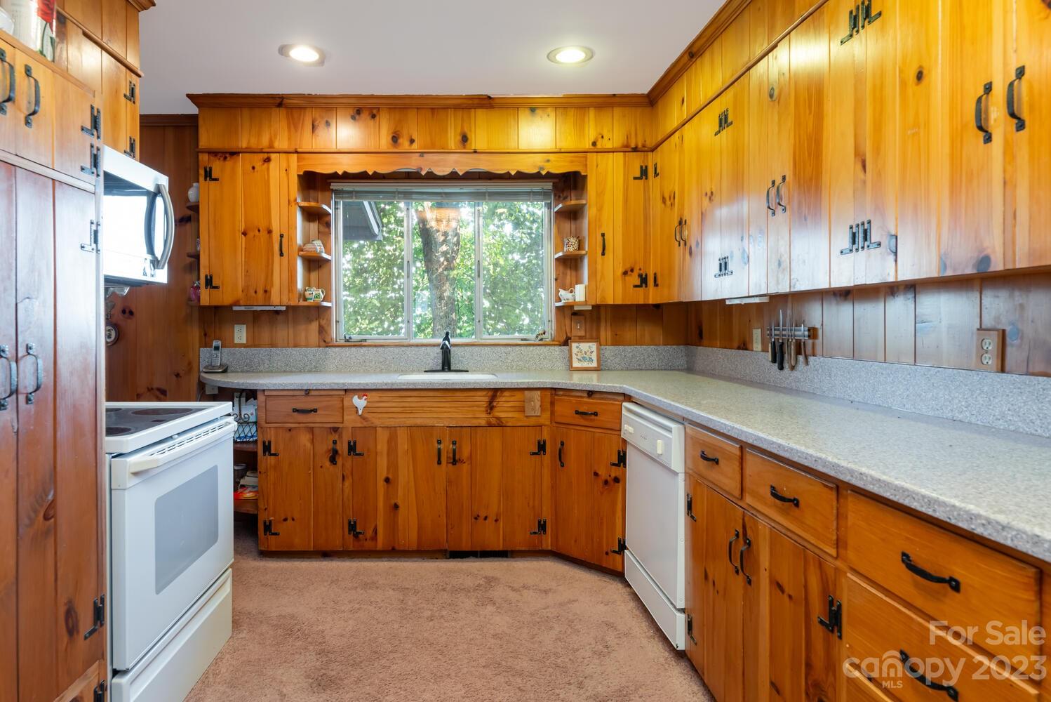 1715 Hogback Mountain Road Tryon, NC 28782 - Photo 15 of 44 a kitchen with stainless steel appliances granite countertop a sink and a refrigerator