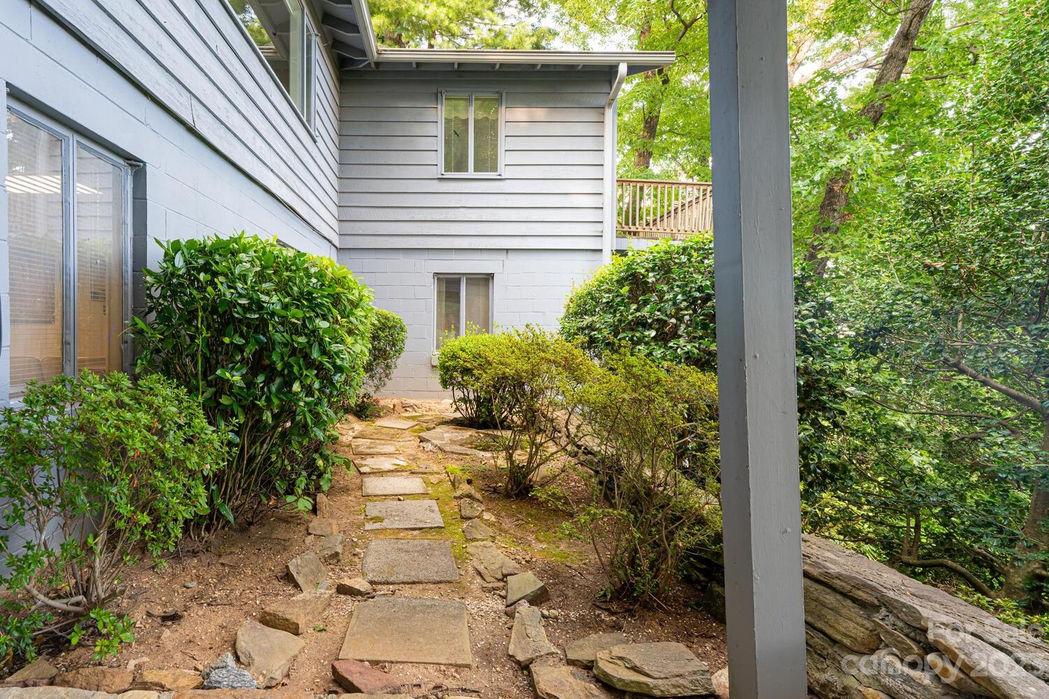 1715 Hogback Mountain Road Tryon, NC 28782 - Photo 39 of 44 a view of a pathway of a house with potted plants