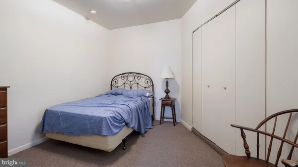 a bedroom with a bed next to a window
