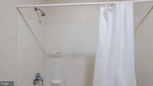 a bathroom with a shower curtain and a window