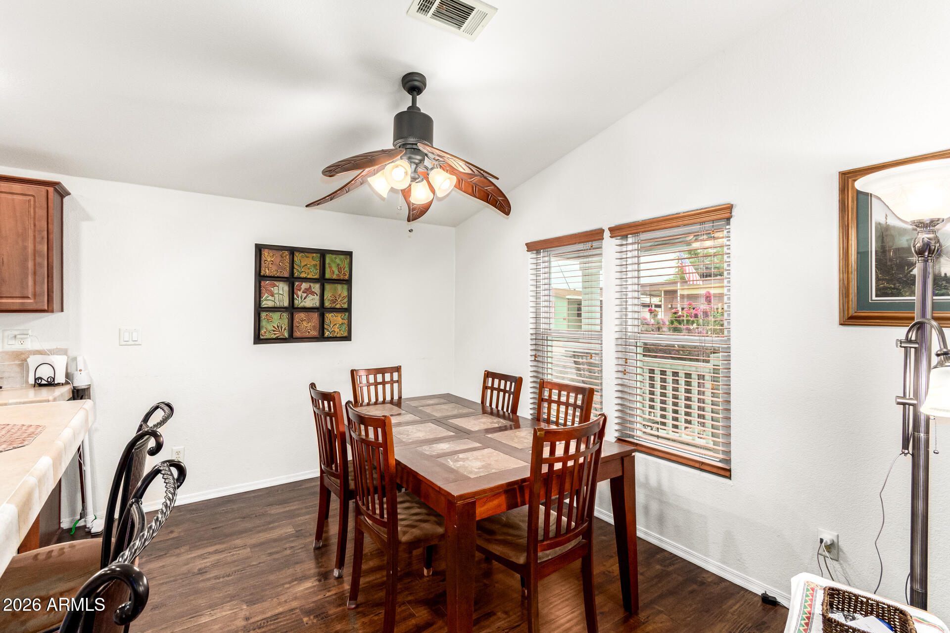 201 South Greenfield Road, Unit 90 Mesa, AZ 85206 - Photo 9 of 32 a view of a dining room with furniture window and wooden floor