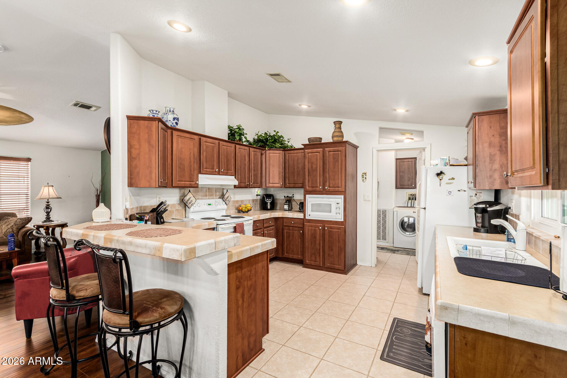 201 South Greenfield Road, Unit 90 Mesa, AZ 85206 - Photo 10 of 32 a kitchen with a sink a stove a refrigerator and cabinets