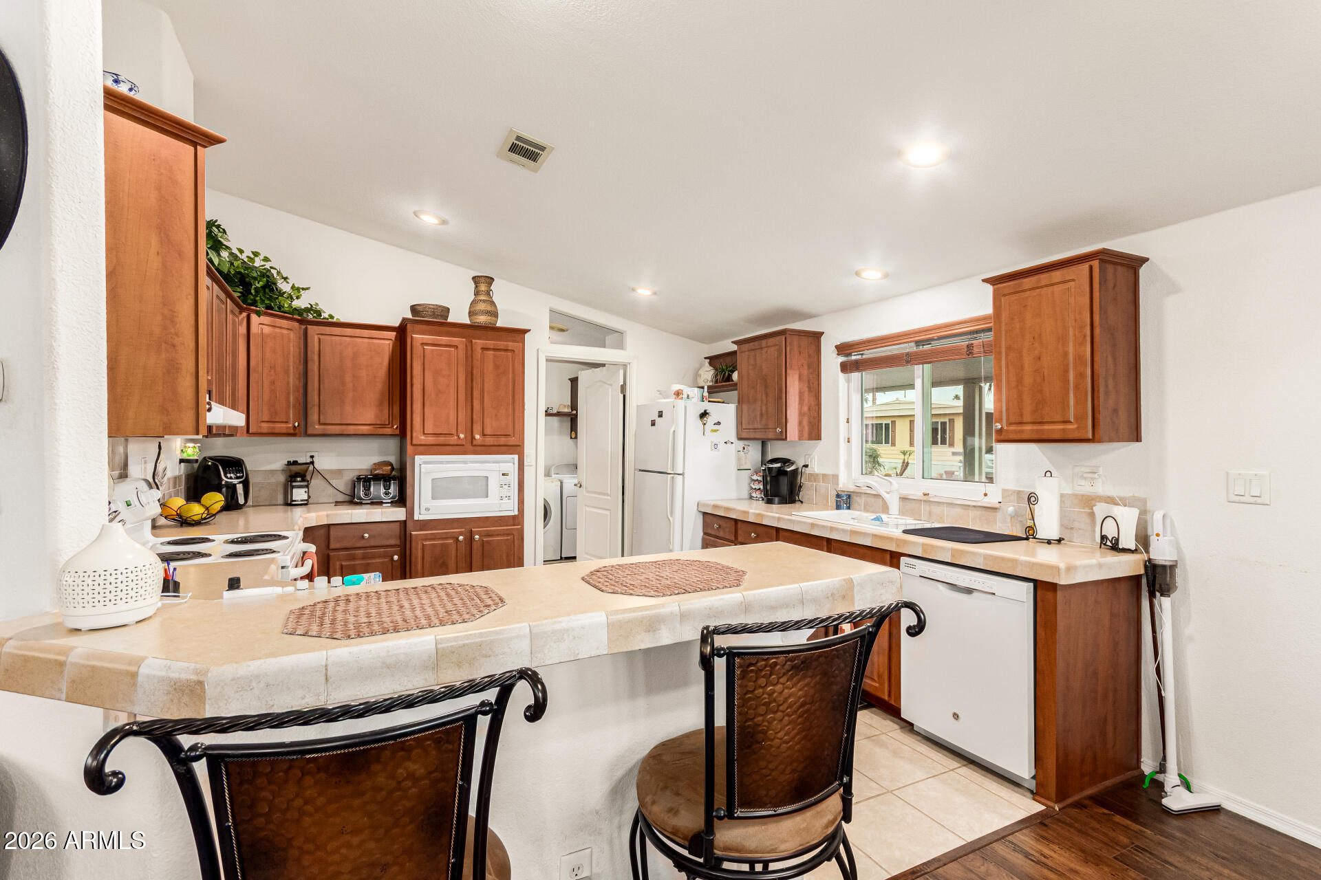 201 South Greenfield Road, Unit 90 Mesa, AZ 85206 - Photo 11 of 32 a kitchen with stainless steel appliances kitchen island granite countertop a sink and cabinets