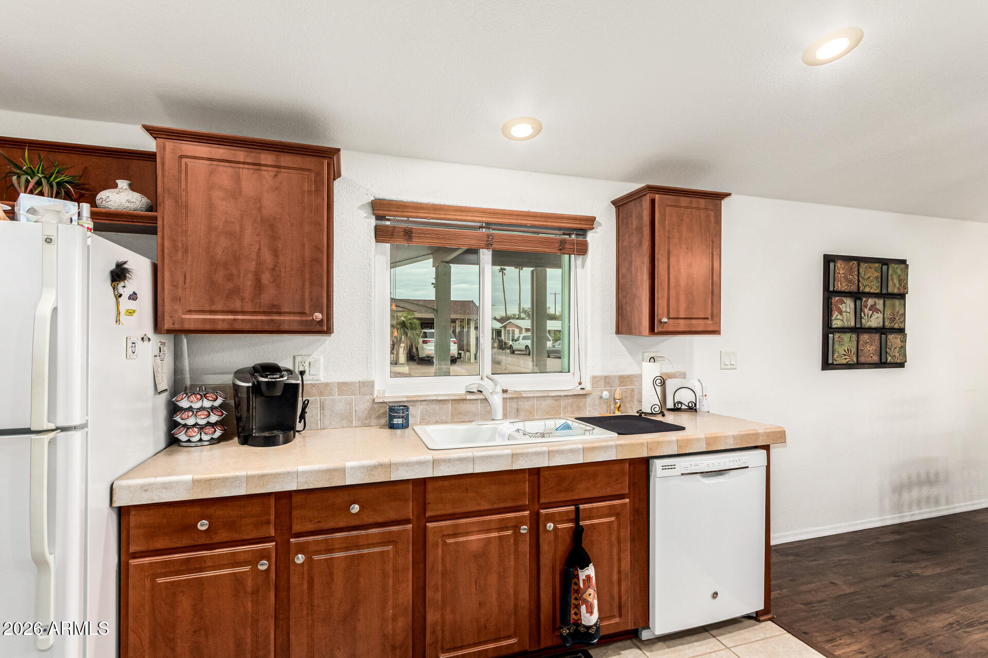 201 South Greenfield Road, Unit 90 Mesa, AZ 85206 - Photo 13 of 32 a kitchen with stainless steel appliances granite countertop a sink stove and refrigerator
