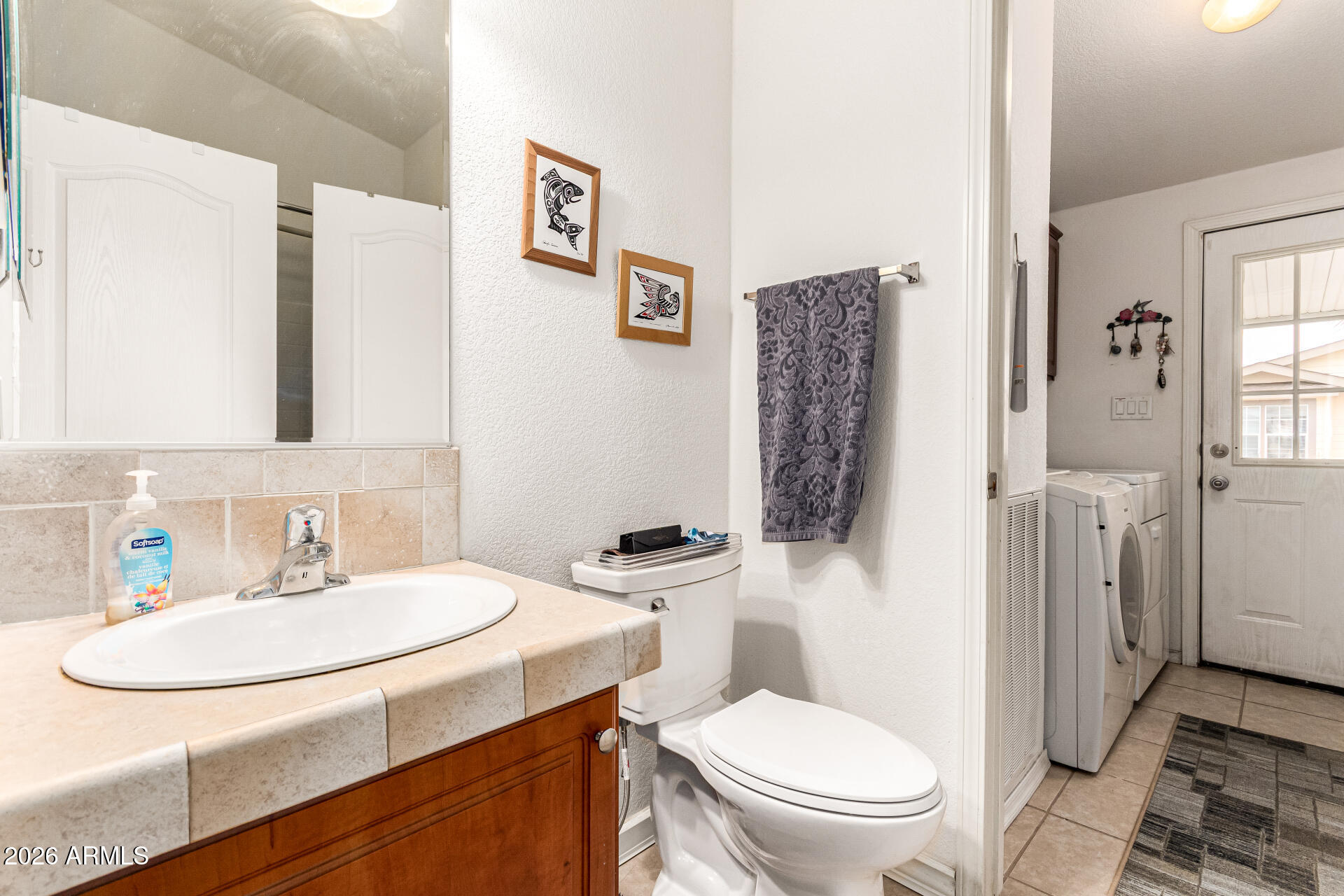 201 South Greenfield Road, Unit 90 Mesa, AZ 85206 - Photo 24 of 32 a bathroom with a sink a toilet and shower curtain