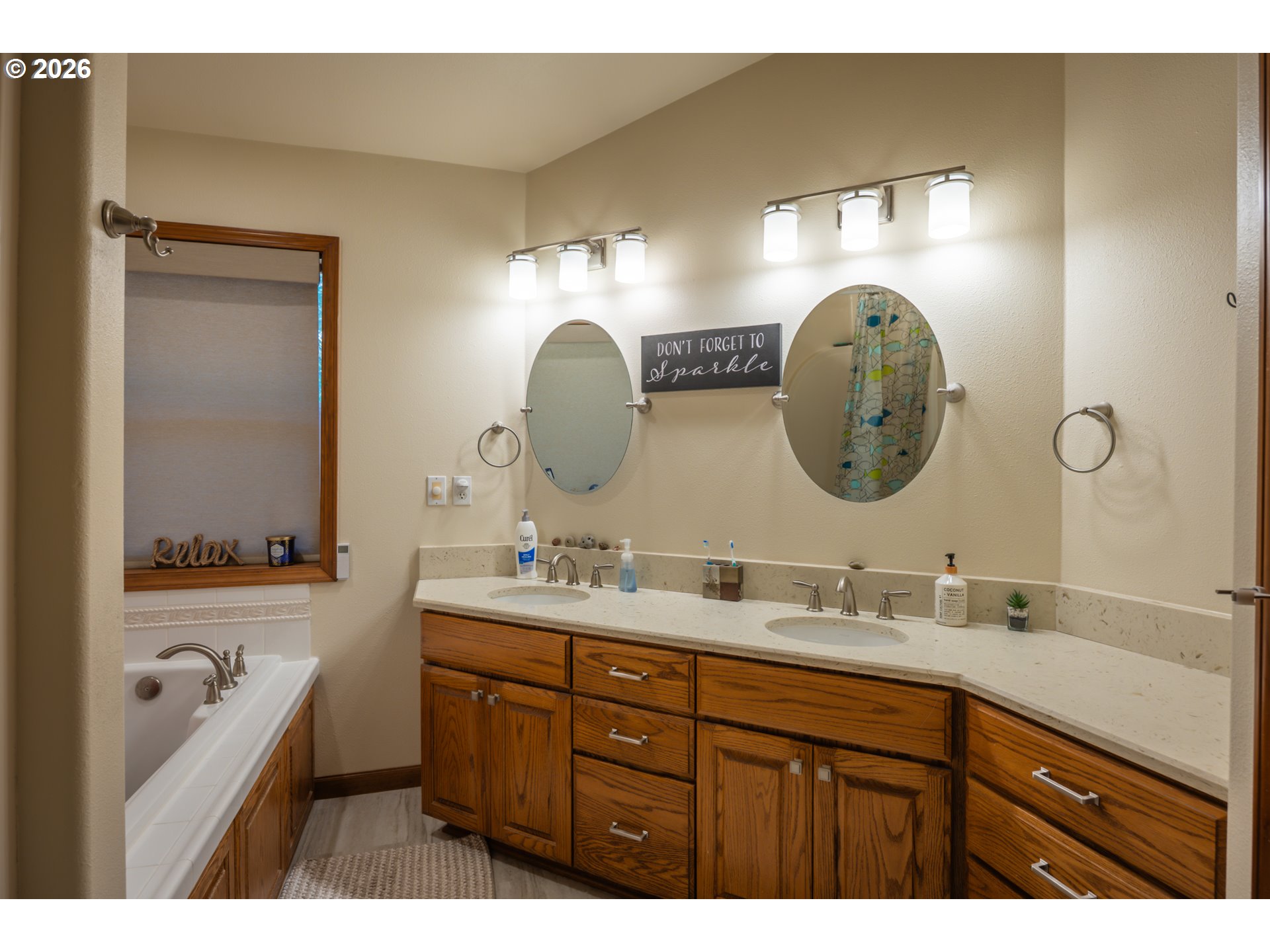 2193 13th Street Florence, OR 97439 - Photo 36 of 48 a en suite bathroom with a double vanity sink and a mirror
