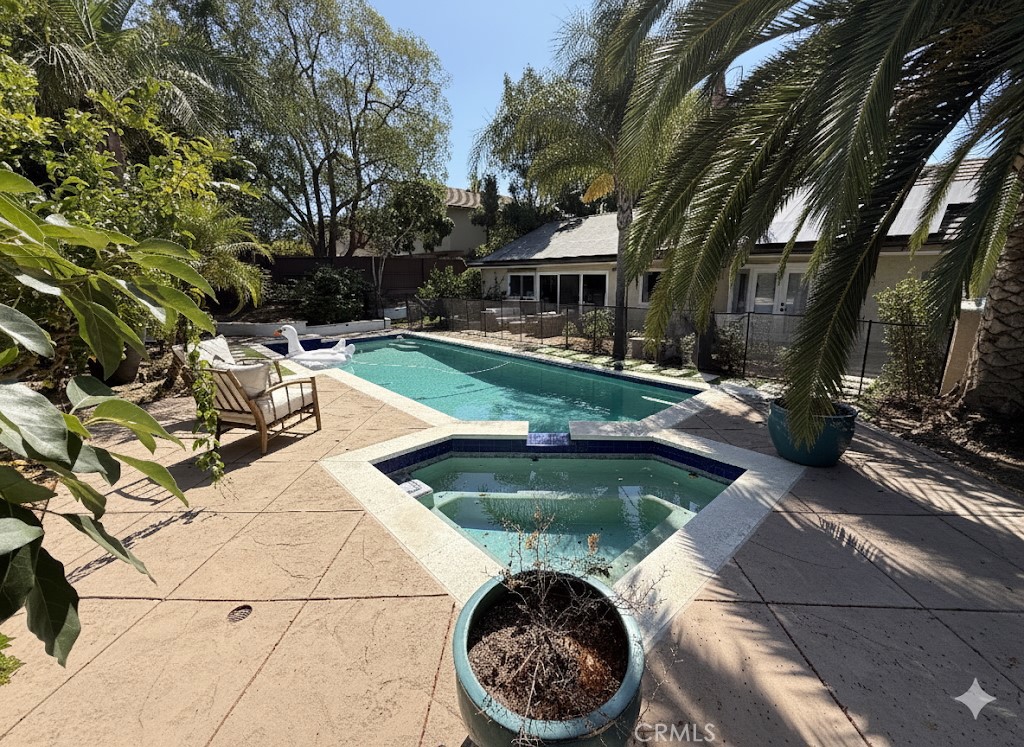 1690 Stoddard Avenue Thousand Oaks, CA 91360 - Photo 2 of 17 a view of a swimming pool with a patio