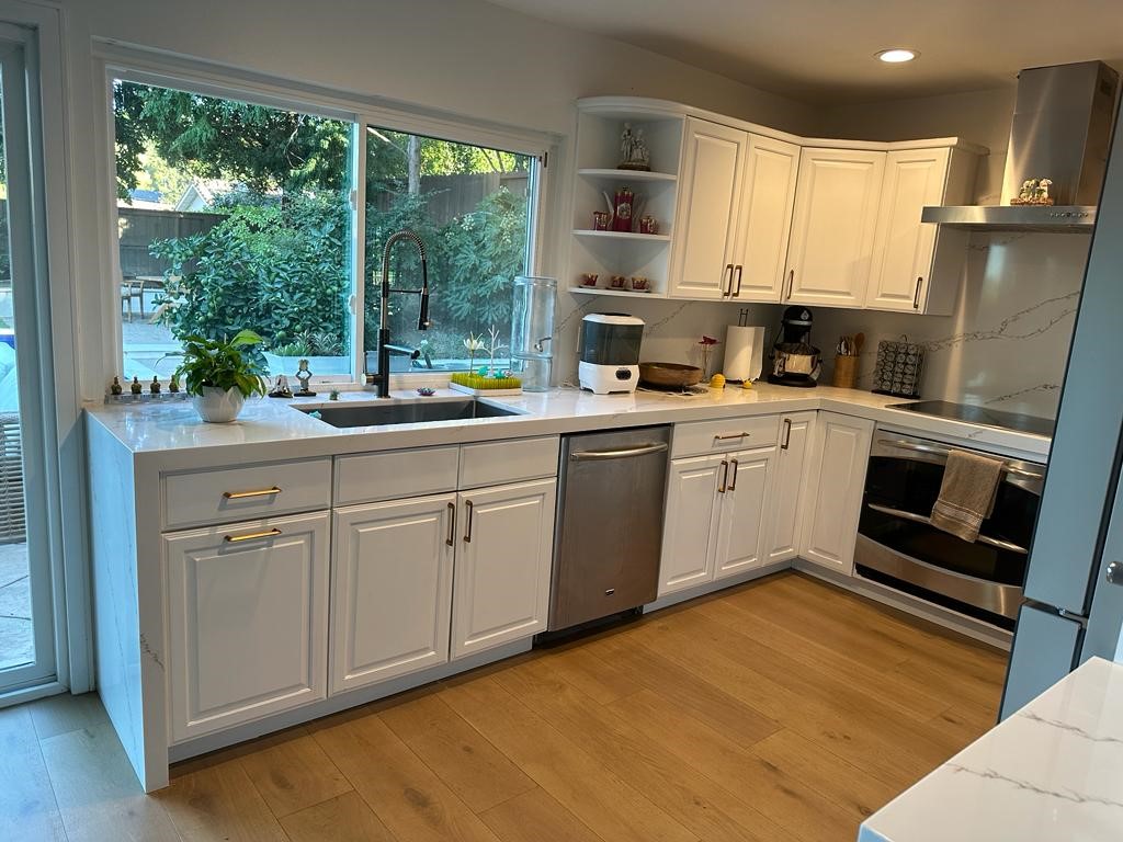 1690 Stoddard Avenue Thousand Oaks, CA 91360 - Photo 7 of 17 a kitchen with a sink stainless steel appliances a window and cabinets