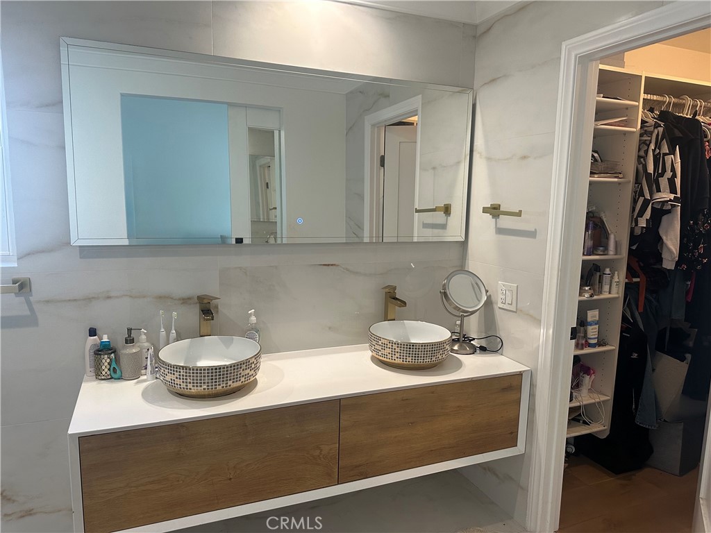 1690 Stoddard Avenue Thousand Oaks, CA 91360 - Photo 10 of 17 a bathroom with a sink and a mirror