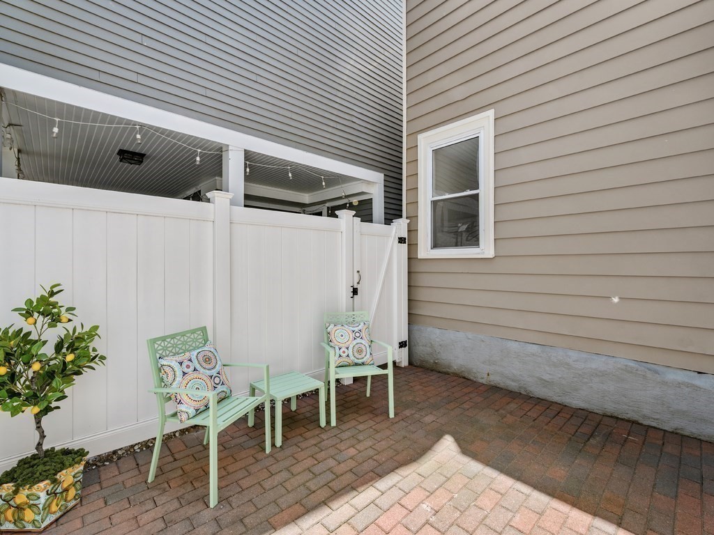 18 R Polk Street Boston, MA 02129 - Photo 18 of 19 a view of patio with table and chairs and potted plants