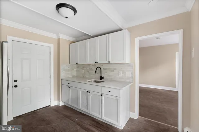 a view of a sink cabinets and a window
