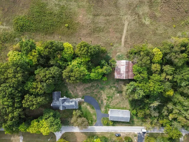 an aerial view of a house with a yard