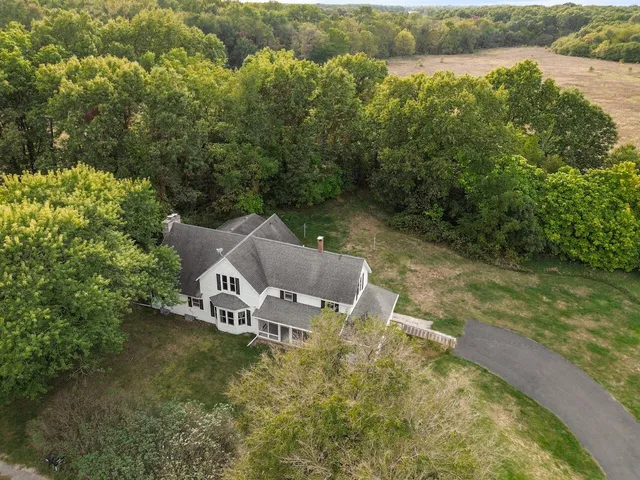 an aerial view of a house with pool lake view and mountain view