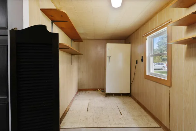 a view of a hallway with wooden floor and entryway