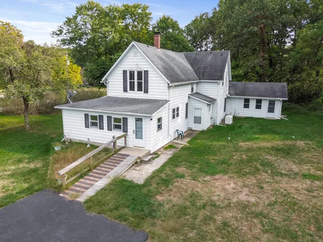 a white house that has a tree in it