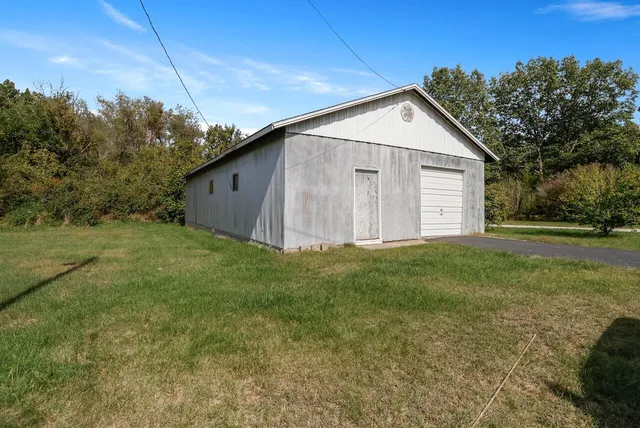 a view of a small house with a yard