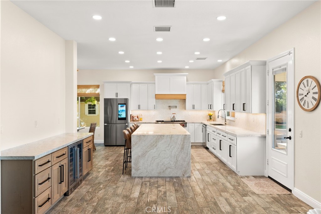 35443 Schafer Ranch Road Yucaipa, CA 92399 - Photo 15 of 67 a large white kitchen with lots of counter space wooden floor and appliances