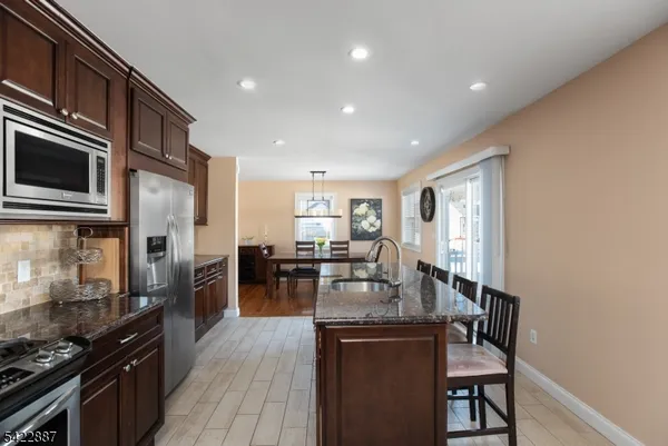 a kitchen with sink stove and refrigerator