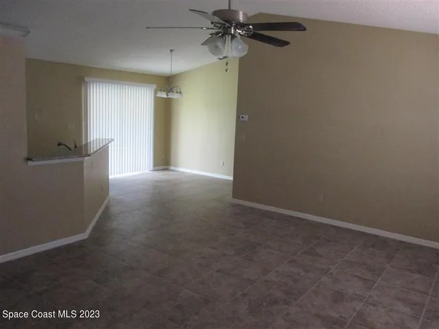 a view of a kitchen with wooden floor and a window