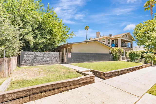 a view of a house with pool and yard