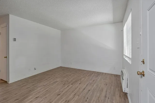 an empty room with wooden floor