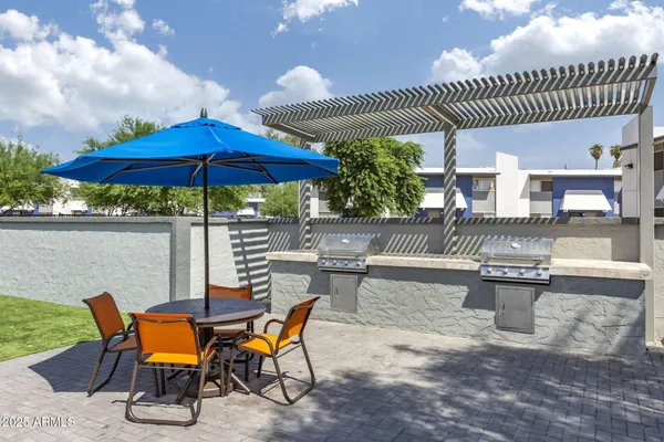 an outdoor space with patio furniture and potted plants