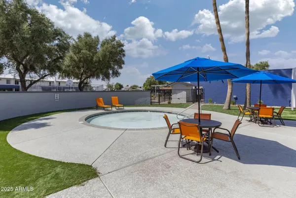 a view of a chairs and table in the patio with a fire pit