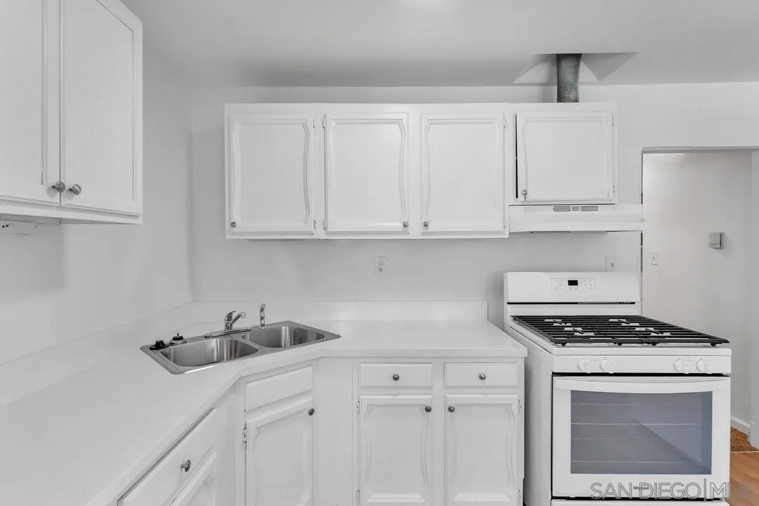7901 Hillside Drive La Mesa, CA 91942 - Photo 16 of 52 a kitchen with white cabinets and sink